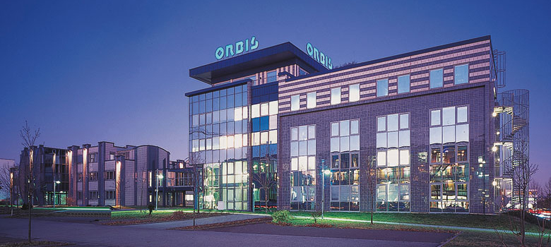 Exterior view of the main building of ORBIS AG at night